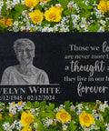 Custom Black Granite Memorial Stone With Your Image For Outdoor Garden And Cemetery Use Personalized Headstone Or Grave Marker Plaque Durable Outdoor Memorial Tablet Forever Keepsake For Loved Ones, featuring engraved portrait and text, placed among flowers.