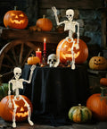 Two 15.7 Inch Hanging Skeleton Decorations With Full Body Posed Joints Realistic Spooky Skeletons For Halloween Decor on pumpkins
