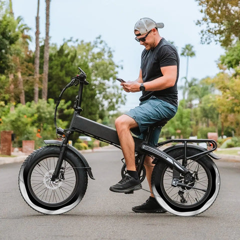 Cyclist on e-bike with 2 Pack Self Sealing Fat E Bike Tubes 20 By 4 Inch Puncture Resistant Inner Tubes With 32mm Schrader Valve Compatible With 20 By 3.5 To 4.0 Fat Bike Tires 89 102 406