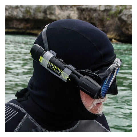 Person using MiniQ40 MK2 Dive Light 250 Lumens Hand Free Underwater Torch with Mask Strap in clear water