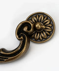 Close-up of zine alloy drawer pull with floral motif, part of Four Piece 150mm Center Drawer Pull Handles in Antique Yellow Bronze Finish.