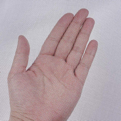 Hand touching fiberglass window screen roll with high visibility and durable mesh for easy DIY rescreen, cut to size for windows