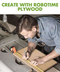 Walnut plywood sheet being measured on a workbench by a man with a tape measure.