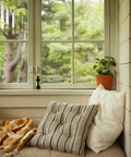 Cozy window nook with pillows and plants, showcasing peaceful indoor setting. Entry Sensor Pack of 4 for Doors and Windows available.