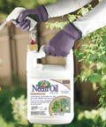 Person spraying Ready To Use Neem Oil For Plants, 128 Oz, Multi Purpose Fungicide Insecticide And Miticide For Organic Gardening.
