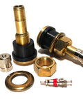Close-up of brass tubeless tire valve stems with clamp-in bases and assorted accessories for trucks and buses.