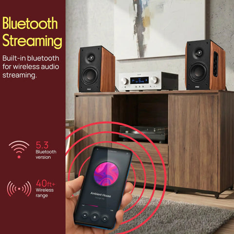 Powered Bookshelf Speakers With Bluetooth, 80W RMS, Bass Reflex Natural Wood Cabinet on a shelf, phone streaming music