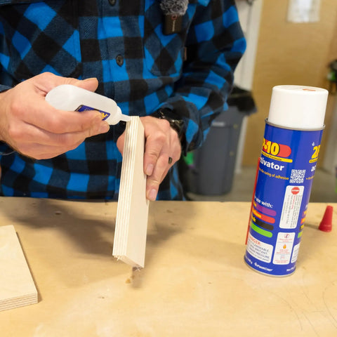 Person applying SoloKit Instant Adhesive And Activator Set For Woodworking Bonds In Ten Seconds to wood piece with activator nearby.