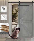 32x84 Inch MDF Light Gray Barn Door with 6.6 Ft Sliding Hardware Kit installed in a living room with visible layering and a cat nearby