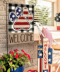 Patriotic USA Flag Paw Print Garden Flag 12x18 Double Sided Outdoor Welcome Banner on porch with plaid and plant decor.