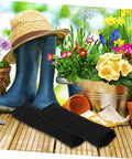Heavy Duty Cut Resistant Arm Guards And Thorn Proof Work Sleeves on wooden surface with gardening equipment and flowers in background.