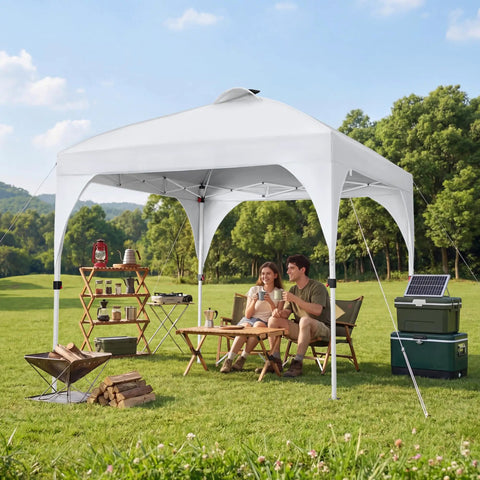 10x10 Pop Up Canopy Tent With Vent For Quick Setup Instant Sun Shelter On Wheeled Bag Includes 4 Sandbags 12 Stakes And 4 Ropes For Parties Beach And Outdoor Use Weather Resistant White, set up in a field with two people sitting underneath.