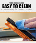 Person cleaning foam base of 2 In 1 Safety-V Push Sticks For Table Saw, Band Saw, Jointer And Router Table Dual Mode