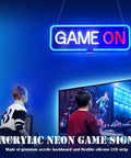Lit Gaming Neon Sign Light For Bedroom Decor 3D Geometry LED Neon Art USB Powered With Acrylic Backboard And Flexible Silicone LED Strip Dope Wall Accent For Gamers. "Game On" text in neon light above boys playing video game.
