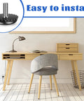 15 Pack 1/4 20 Adjustable Furniture Levelers Built From Heavy Duty Stainless Steel Screw In Feet on a desk setup with a lamp.