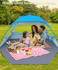 Family enjoying a picnic in a Tons Of Room Beach Shade Tent For 3 To 10 People With UPF 50 Plus UV Protection Lightweight Pop Up Sun Shelter