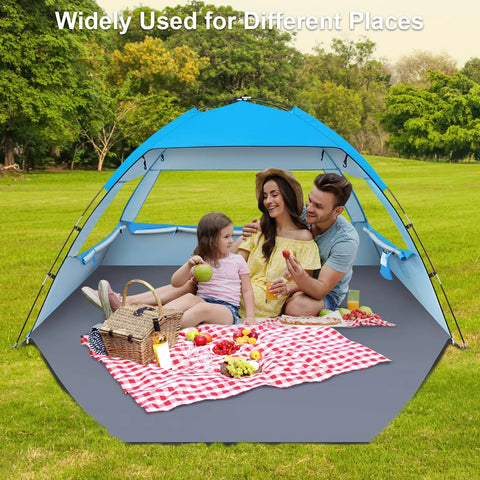 Family enjoying a picnic in a Tons Of Room Beach Shade Tent For 3 To 10 People With UPF 50 Plus UV Protection Lightweight Pop Up Sun Shelter