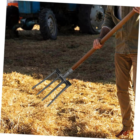 Steel Garden Fork Replacement Head Four Tine Heavy Duty Digging Fork handling straw in a farm setting