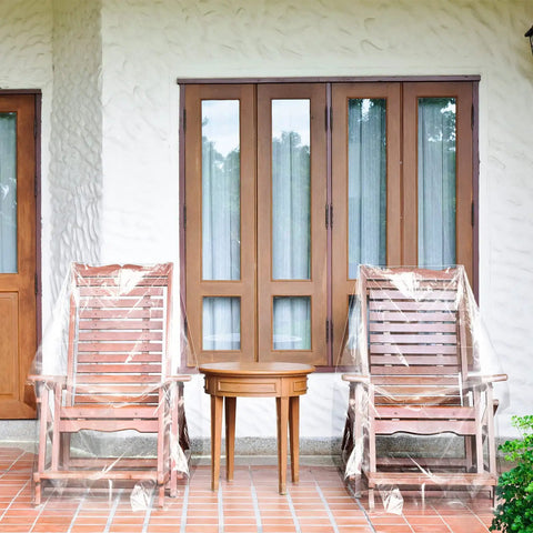 4 Pack Outdoor Clear Plastic Chair Covers Waterproof Dust Proof Fits Chairs Sofas Couches and Recliners 37 x 30 x 30 Inches Protection for Furniture Moving and Storage shown covering two patio chairs.