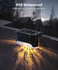 16 Pack Solar Deck Lights For Stairs And Fences Setting Those Sweet Backyard Vibes With A Dang Nice Warm White Glow Plus No Sweat Mounting And Zero Electric Bills To Level Up Your Weatherproof Yard, shown in rain.
