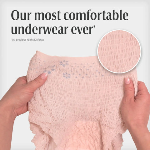 Hands holding Night Defense Adult Incontinence Underwear For Women, Overnight Maximum Absorbency Disposable Diapers, Medium, Blush