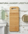 No Sweat Bamboo Washboard For Hand Washing Clothes With Non Slip Base And Deep Grooves To Hustle Out Tough Stains From Shirts Socks And Undies Portable Wooden Laundry Scrubber For Sink Or Campout on a wooden table.