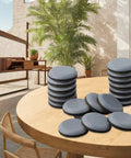 Stacked heavy duty furniture sliders with 30mm PTFE glides on a wooden table, suitable for chairs and sofas on wood and carpet