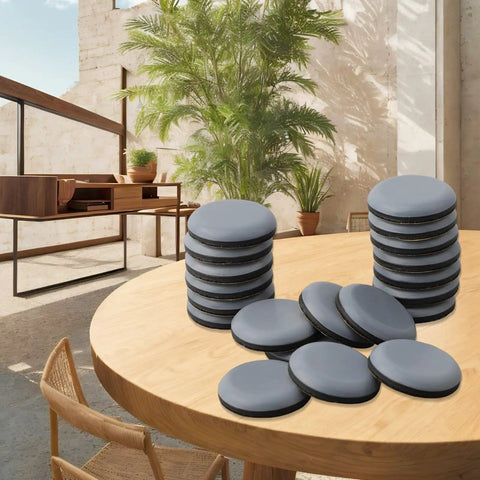 Stacked heavy duty furniture sliders with 30mm PTFE glides on a wooden table, suitable for chairs and sofas on wood and carpet