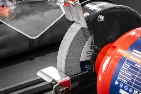Close-up of Workhorse 150Mm Bench Grinder equipped with a coarse 150mm grinding wheel and spark shield, designed for tough tasks.