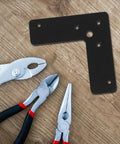 Stainless Steel Corner Brackets 4 Pack L Shaped Built Tough 100x100mm 2mm Thick Wear Resistant Black Shelf Braces on wood surface
