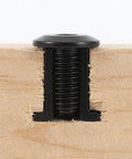 Black Furniture Connector Bolts And Barrel Nuts 40 Piece Kit For Rock Solid Bed Frame And Cupboard Assembly showing a bolt secured within wood.