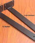 Heavy Duty 12 Pack Hidden L Shelf Brackets 12 Inch Matte Black Iron Floating Wall Mount Hardware For Rustic Industrial Shelving Built Different To Support 100 Lbs Per Pair, showing 12 inch brackets on wooden surface.