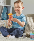 Child playing with Seasonal Sensory Tubes For Calming Kids in a cozy room, showcasing chill out fidgets for travel and school.