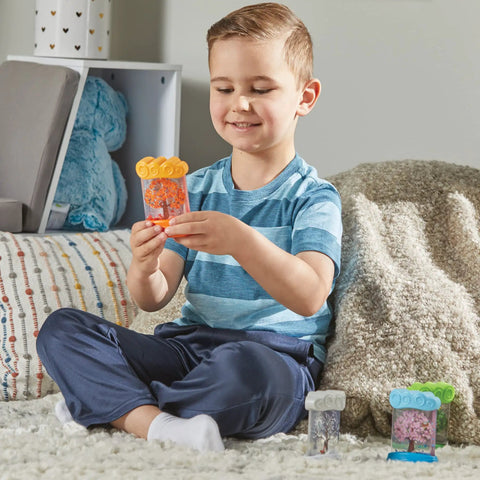 Child playing with Seasonal Sensory Tubes For Calming Kids in a cozy room, showcasing chill out fidgets for travel and school.