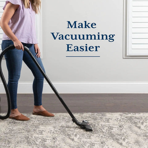 Person vacuuming on Rug Gripper Pad For Hardwood Or Tile Floors 2x3 Ft Thick Non Slip Under Rug Mat Keeps Rugs From Bunching And Sliding