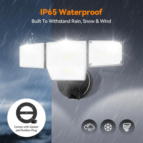 85W LED Flood Lamp Sheds 10000 Lumens Of Real Juice With Four Pivot Heads And Dusk To Dawn Switch For Solid Yard Defense shown in rain with IP65 waterproof feature.