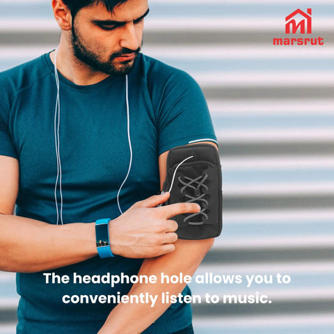 Person using arm strap phone holder with headphone hole for convenient music listening during workout.