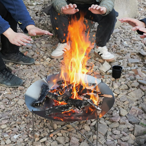 Portable 20 Inch Stainless Steel Wood Burning Fire Pit With Folding Grill And Carry Bag Ultra Compact in use at campsite