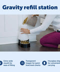 Woman refilling Hassle Free Double Pack Small Gravity Pet Food Station With Stainless Steel Bowl For Cats And Dogs.