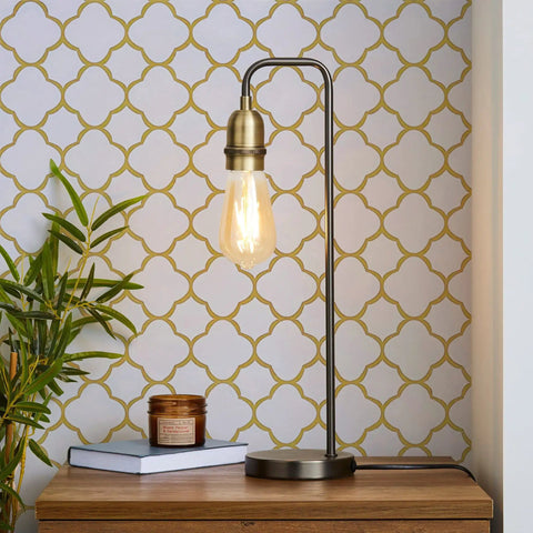 Lamp on table in front of white and gold peel and stick wallpaper self adhesive removable trellis pattern for walls and furniture modern gold grid vinyl roll for bedroom kitchen renovation and DIY decor.