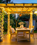 200 LED String Lights 66 Ft Connectable Warm White Cozy Glow Christmas Fairy Lights adorning outdoor patio pergola.