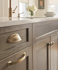 Kitchen cabinet featuring Golden Champagne Ashby Cabinet Cup Pull for 3 Inch Center To Center and 4 Inch Center To Center Spacing