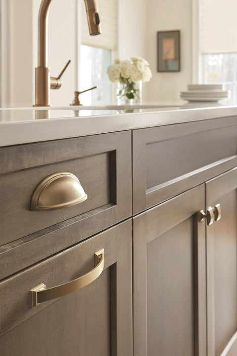 Kitchen cabinet featuring Golden Champagne Ashby Cabinet Cup Pull for 3 Inch Center To Center and 4 Inch Center To Center Spacing