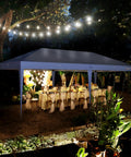 Ten By Twenty Foot Pop Up Canopy Tent With Six Sidewalls Blue Outdoor Gazebo For Patio Events Easy One Or Two Person Setup In Minutes Includes Carry Bag Premium Commercial Grade Party Shelter at nighttime event with lights.