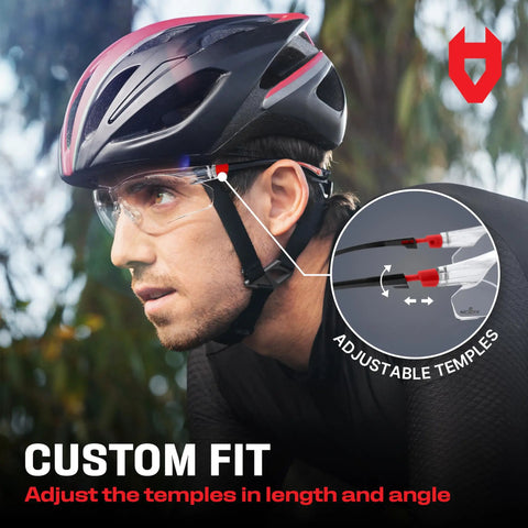 Cyclist wearing clear anti fog safety glasses with scratch resistant wraparound lenses and adjustable temples, ANSI Z87 certified.
