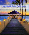 Outdoor scene with eight Solar Torch Lights With Flickering Flame For Outdoor Yards And Pathways, lighting a walkway.