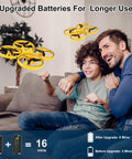 Child flying yellow Gesture Control Drone For Kids Hand Sensor RC Quadcopter With Smart Watch Control indoors with adult, extra batteries shown.