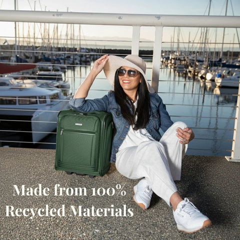 Woman sitting by marina with Underseat Carry-On Luggage With 28L Capacity, Sustainable Travel Bag Made From Recycled RPET in Juniper Green.