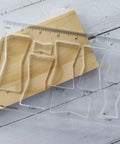 Rock Solid Acrylic 8 In 1 Bowtie Butterfly Router Template Jig Kit Woodworking DIY Inlay Guide on wooden surface with ruler.