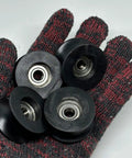 4 Pack Black 8x40x20mm U Groove Pulleys With PA Coated Nylon Bearings And Stainless Steel S608Z Bearings Durable Plastic Roller Wheel Set For Small Belt Drive Systems on a gloved hand